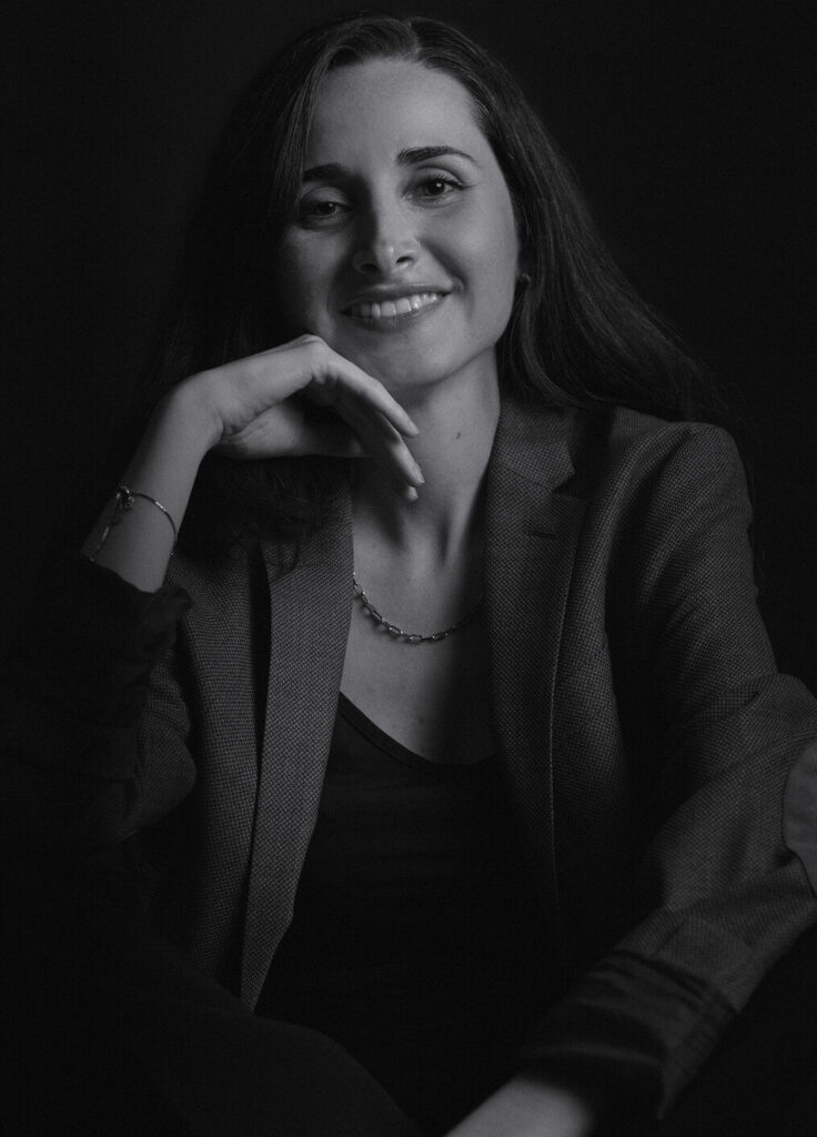 Woman smiling and resting cheek on the back of her hand